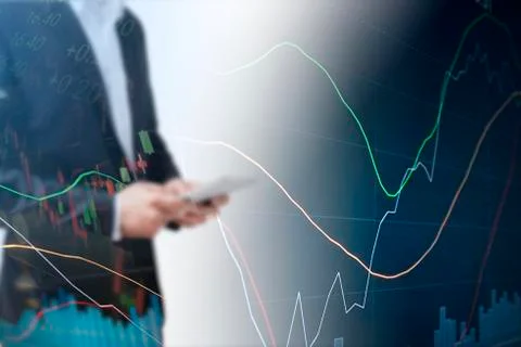 Businessman using tablet analyzing sales data and economic growth graph chart 写真素材