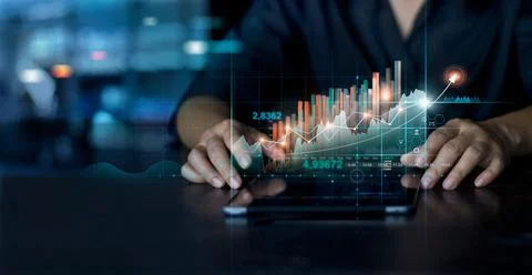 Businessman using tablet analyzing sales data and economic growth graph chart 스톡 사진
