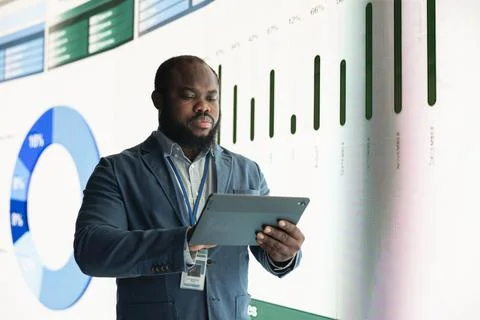 Businessman using tablet app to prepare financial charts report for shareholders Stock Photos