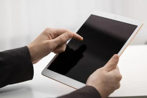 Businessman using tablet on blurred background, closeup. Modern technology 스톡 사진