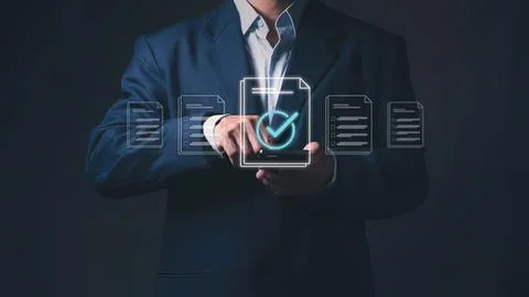 Businessman using tablet with checkmark and documents Stock Photos