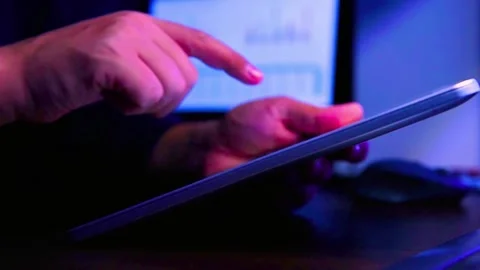 Businessman using tablet close up in dark room with cinematic lighting Stock-Footage 342906087