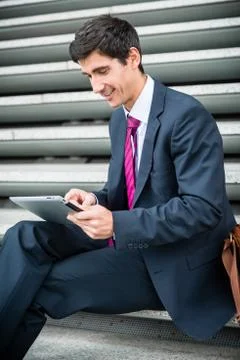 Businessman using a tablet for communication or data storage out 写真素材