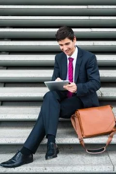 Businessman using a tablet for communication or data storage out 스톡 사진
