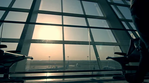 Businessman using tablet computer at the airport. silhouette of a man traveler Stock Footage 66480220