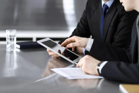 Businessman using tablet computer and work together with his colleague or Stock Photos