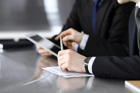 Businessman using tablet computer and work together with his colleague or Stock Photos