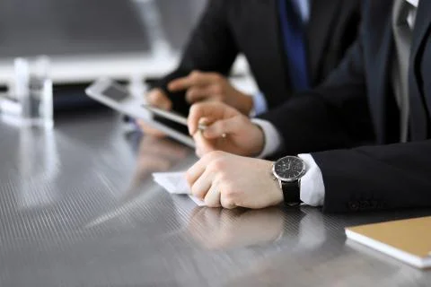 Businessman using tablet computer and work together with his colleague or Stock Photos