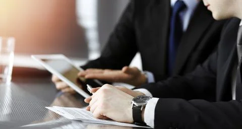 Businessman using tablet computer and work together with his colleague in sunny Stock Photos
