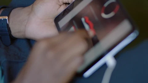 Businessman using tablet computer browsing graph research data working on Stock Footage 94858630