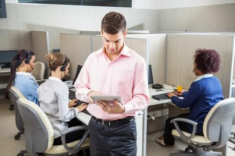 Businessman Using Tablet Computer In Call Center Stock Photos