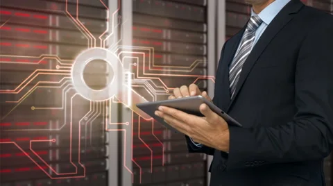 Businessman using tablet computer in front of locked server tower Stock Footage 52015965