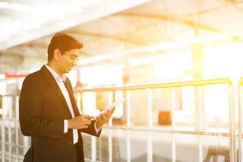 Businessman using tablet computer at railway station Stock Photos