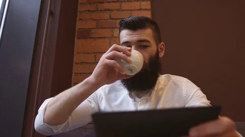Businessman using tablet computer touchscreen in cafe Stock Footage 74007916