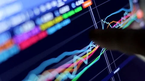 Businessman using tablet computer viewing stock charts graphic Stock Footage 79737248