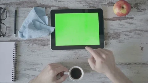 Businessman using tablet computer working from home, drinks coffee Stock Footage 79267336