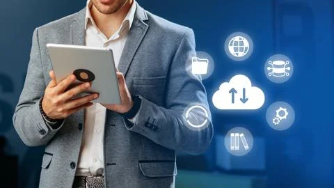 Businessman using a tablet with icons of technology in a modern office setting Stock Photos
