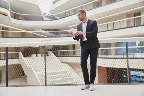 Businessman using tablet in office building Fotos de archivo