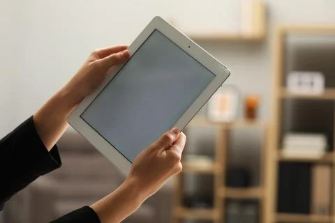 Businessman using tablet in office, closeup. Modern technology 스톡 사진