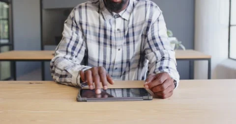 Businessman using tablet at office desk, focusing on digital work Stock Footage 346296191