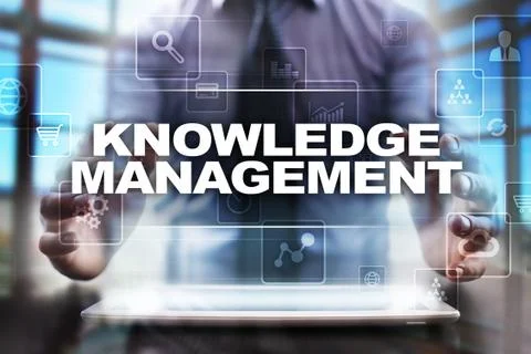 Businessman using tablet pc and selecting knowledge management. Stock Photos