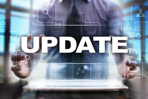 Businessman using tablet pc and selecting update. Stock Photos