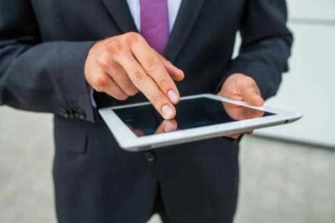 Businessman using tablet pc. Close up. Stock Photos