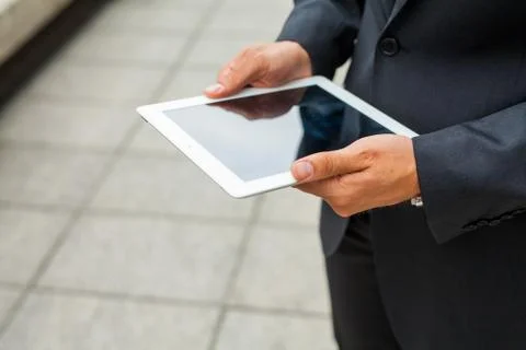 Businessman using tablet pc. Close up. Stock Photos