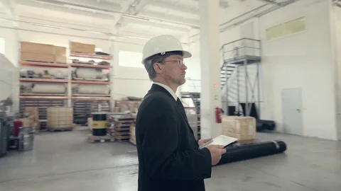 Businessman using tablet pc at manufacturing plant Stock Footage 74897328