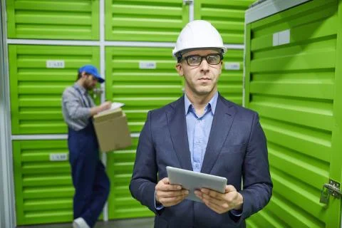 Businessman using tablet pc in warehouse Stock Photos