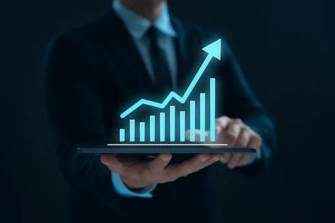 Businessman using tablet to show graphs and charts of business and company .. Stock Photos