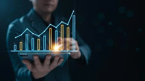 Businessman using tablet to show graphs and charts of business and company .. Stock Photos