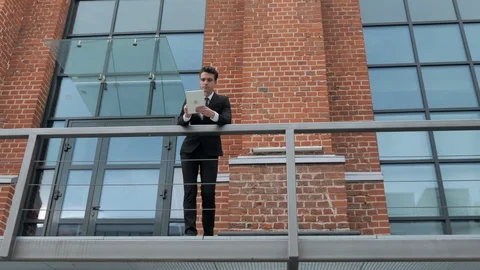 Businessman Using Tablet Standing Outside Loft Office Video stock 94853089