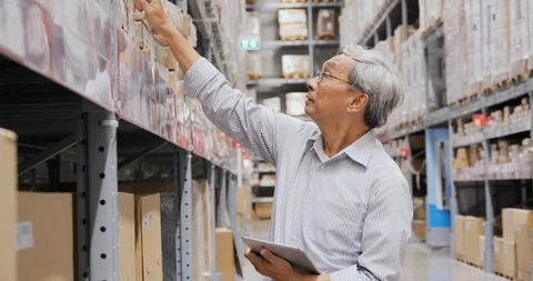 Businessman using tablet for working at warehouse. Stock Footage