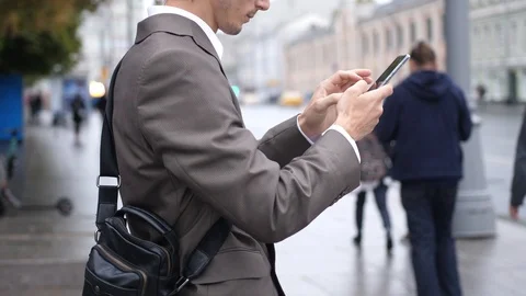 Businessman using touch Mobile Phone outdoor on the street Stock Footage 125502976