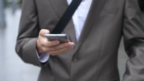 Businessman using touch mobile Phone outdoor, close up, man walking with cell Stock-Footage 126024675
