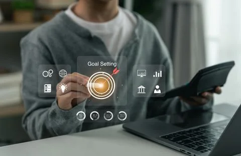 Businessman using virtual interface with digital icons and graphic charts f.. Stock Photos