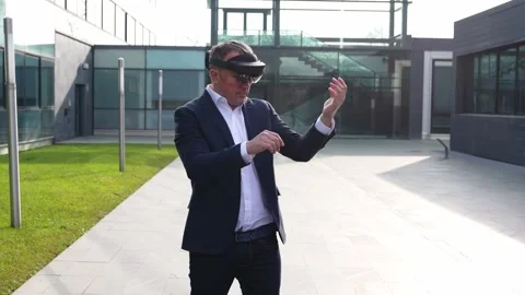 Businessman Using Virtual Reality Headset Outdoors at Modern Office Stock Footage 275860894
