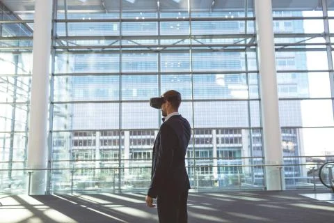 Businessman using virtual reality headset in a modern office building Fotos de archivo