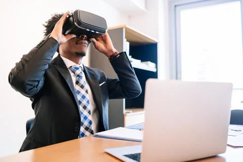 Businessman using virtual reality headset Stock Photos