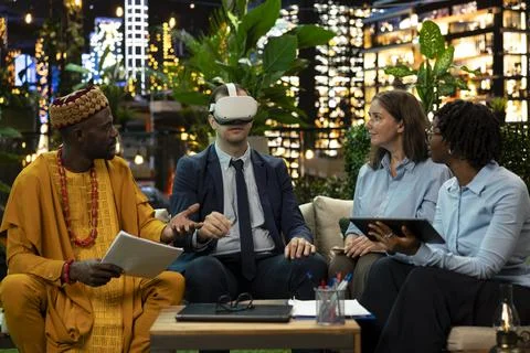 Businessman using virtual reality headset during business meeting Stock Photos