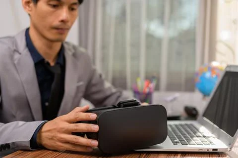 Businessman is using VR glasses to work. Virtual world. Stock Photos