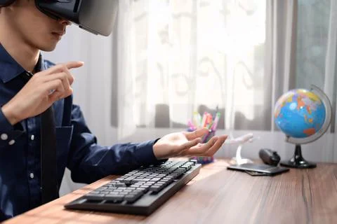 Businessman is using VR glasses to work. Virtual world. Stock Photos
