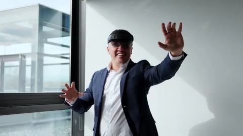 Businessman using VR headset, demonstrating augmented reality in modern offic Stock Footage 275861107