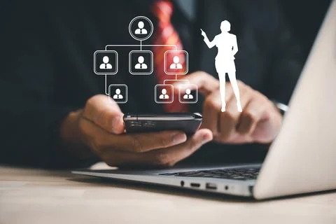 Businessman utilizing digital technology and a holographic interface to choose Stock Photos