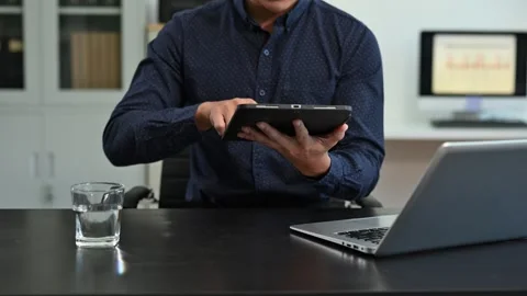 Businessman utilizing smartphone and tablet technology. Perfect for corpora.. Stock Footage 313460764