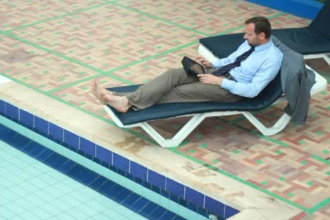 Businessman on vacations with tablet computer by the pool Stockbeeldmateriaal 10842068
