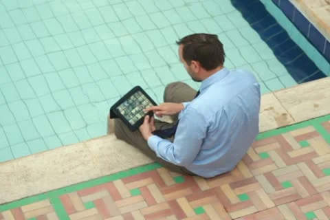 Businessman on vacations with tablet computer by the pool Видео 10842075