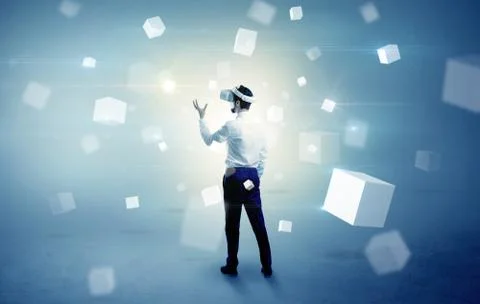 Businessman with vr goggle and falling cubes Stock Photos