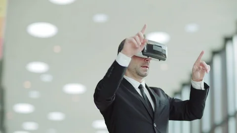 Businessman in VR headset exploring data Stock Footage 108682003